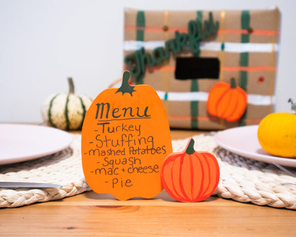 wooden pumpkin menu on thanksgiving table