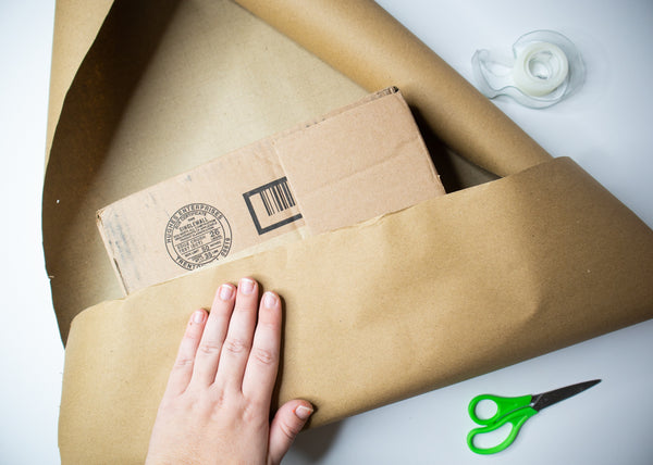 Wrapping a cardboard box with craft paper