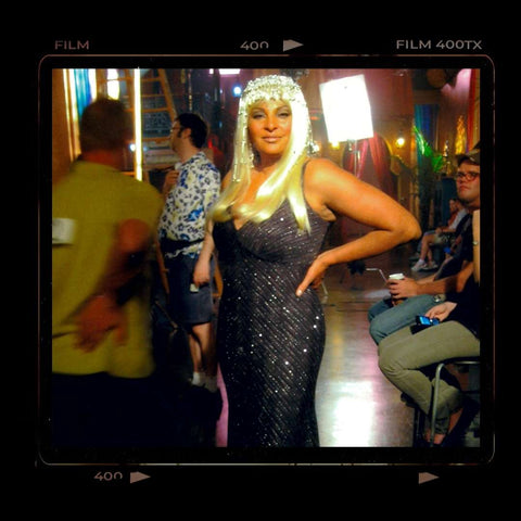 Film polaroid style photo of Pam Grier super glam look with platinum blond wig and fabulous sparkly cocktail dress