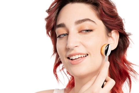 Best cruelty free buffer brush used by model on her face showing the comfortable handle
