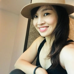 Heidi Chen wearing a felt hat smiling at the camera