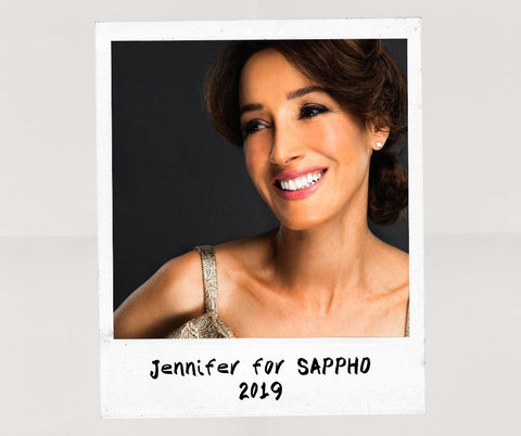 Jennifer Beals close up, smiling, wearing natural makeup look created using SAPPHO clean beauty products in 2019