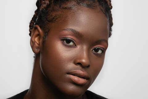 Black model wearing pink jewel tone makeup using natural and vegan products