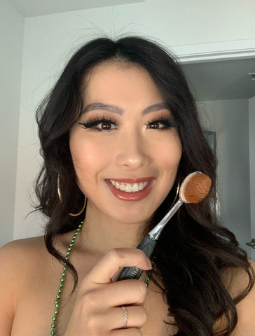 Clean beauty makeup brand SAPPHO team member Lily holding up her favorite buffer brush