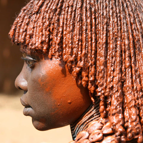 Ethiopian woman with red ochre face and hair paint