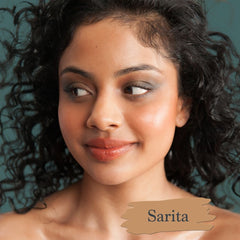 Caramel brown skin model wearing Sarita foundation shade for Essential natural foundation