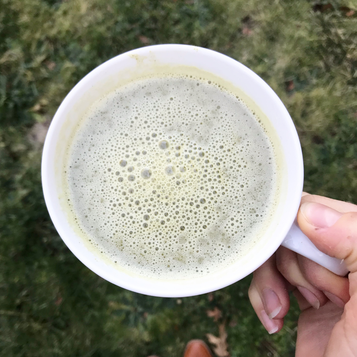 Mug of frothy match CBD latté 