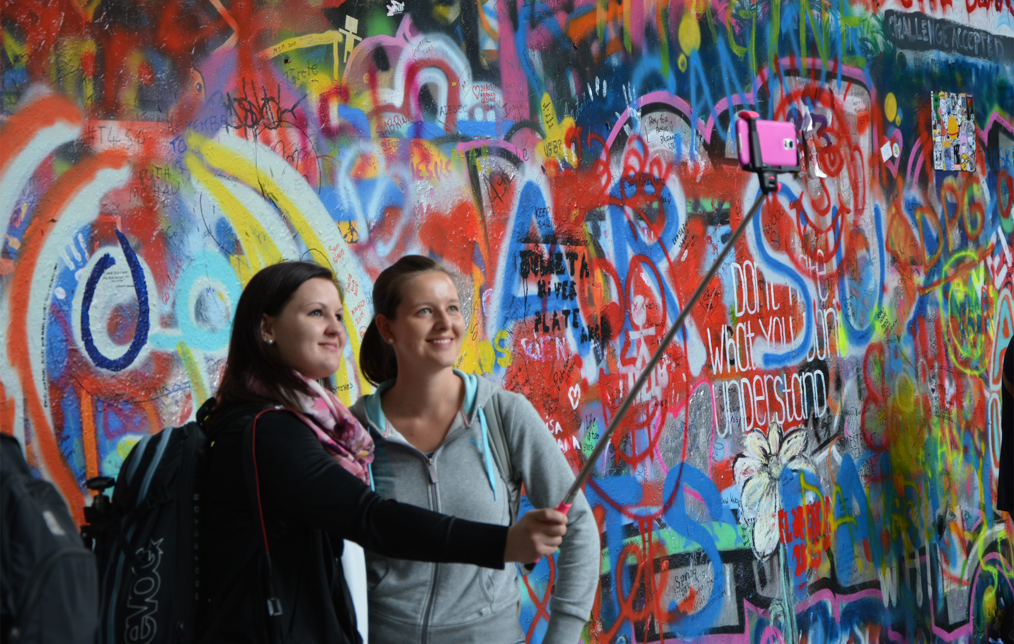 tourist selfie in front of grafiti 