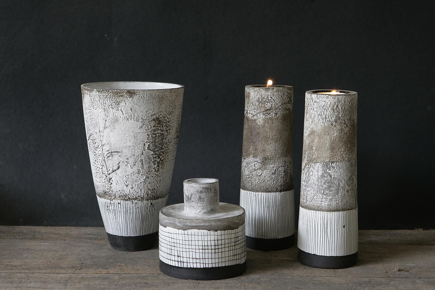A collection of Helen Vaughan ceramics. These vases, vessels and candle sticks feature a neutral color palette and her signature sgraffito texture. Helen Vaughan ceramics are available at Sarza home décor Store in Rye, New York.