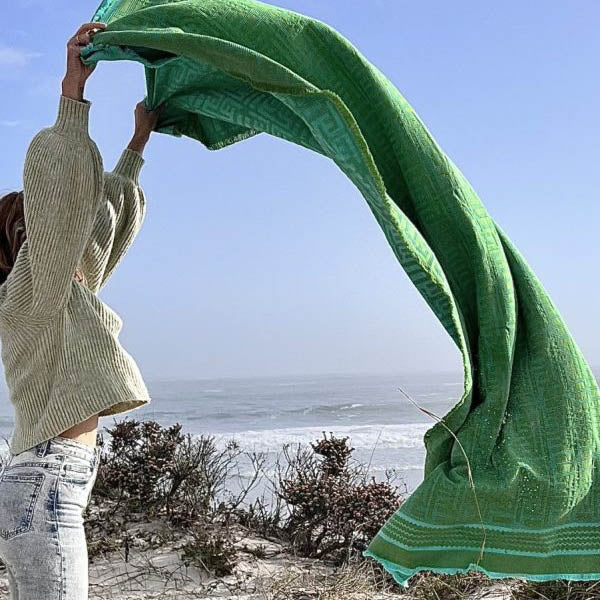 African Jacquard beach mats and beach towels on the beach in South Africa. African Jacquard home linens and textiles are available at Sarza home décor Store in Rye, New York.