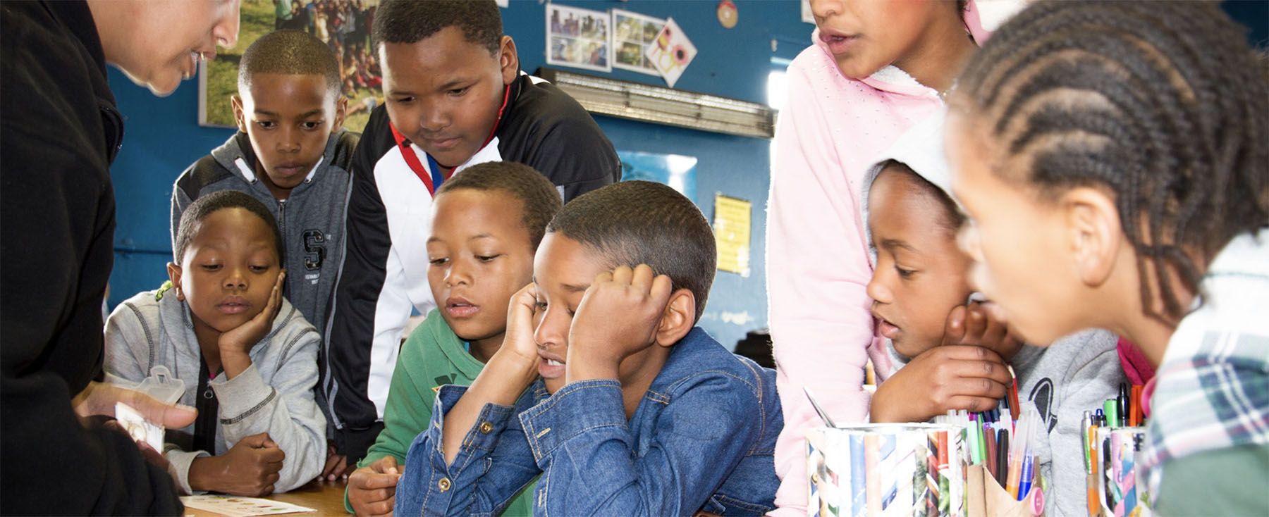 Photo of children learning. The Cape Island brand supports this cause. Cape Island luxury candles, soap products and home fragrances are available at Sarza home goods and furniture store in Rye New York