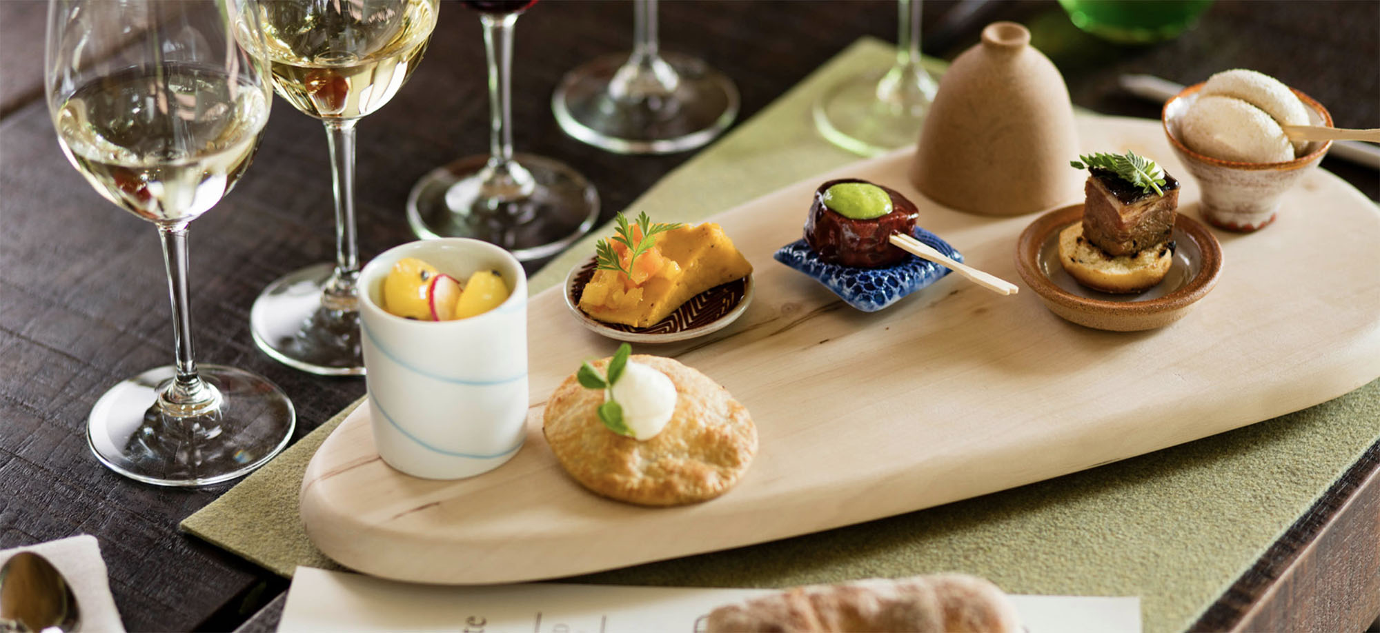 Coco Africa wooden serving board with a selection of tapas on it. Coco Africa home décor products are available at Sarza home goods and furniture store in Rye New York