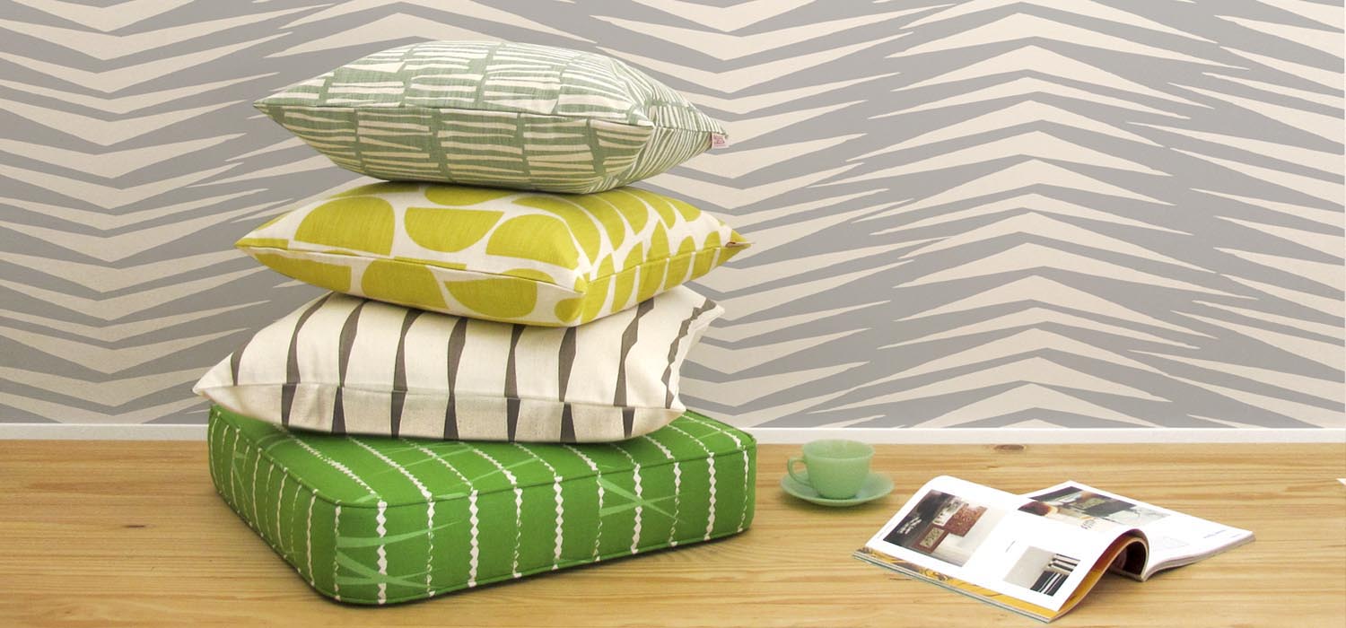 Skinny laMinx wallpaper and pillows in bright colors. Available at Sarza home goods and furniture store in Rye New York.