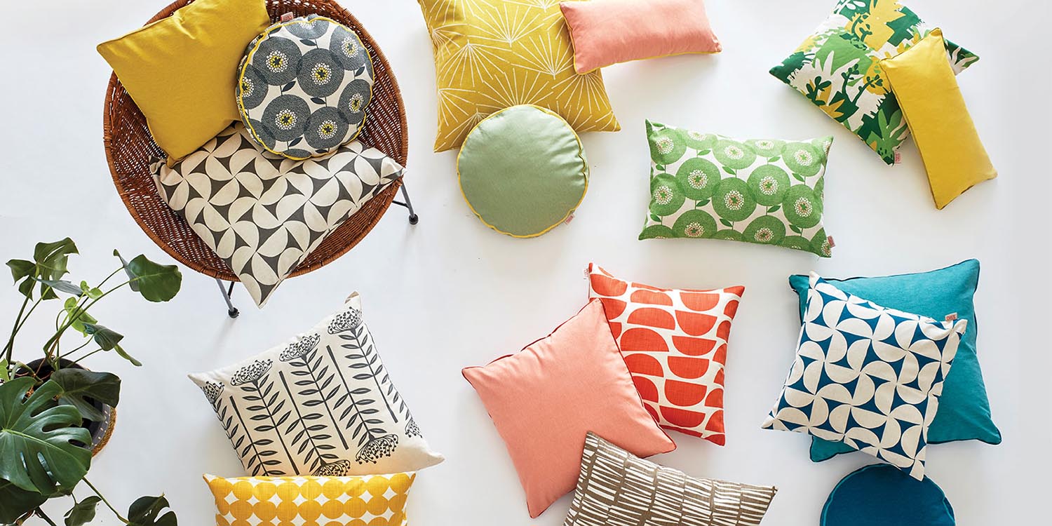 A trio of Skinny laMinx pillows in bright colors and patterns. Available at Sarza home goods and furniture store in Rye New York.