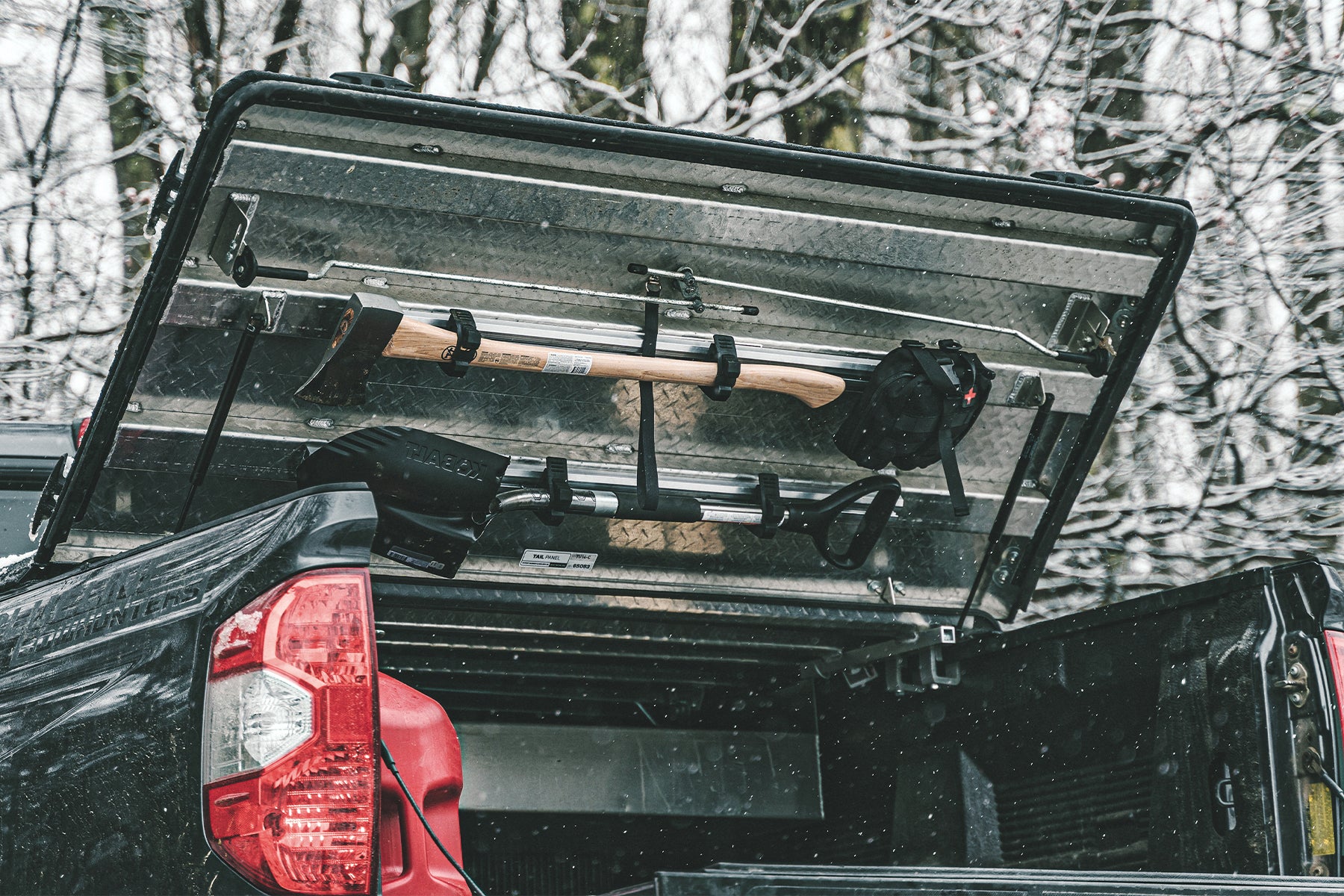 truck cover in snow with shovel and axe