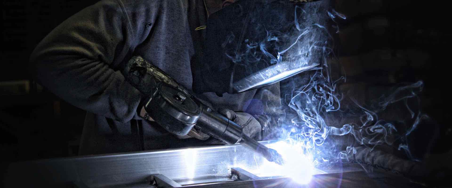 A Philipsburg man welds a DiamondBack ATV ramp