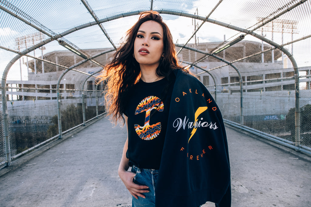 Zharmila on the Bart overpass looking amazing in the navy tree tee with hoodie draped over her shoulder.