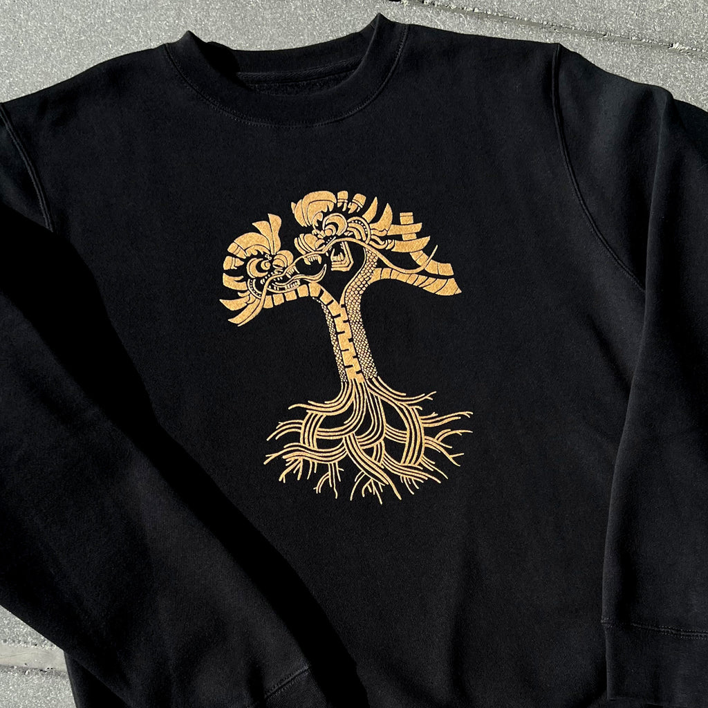 Black crewneck sweatshirt with dragon power artwork in metallic gold.