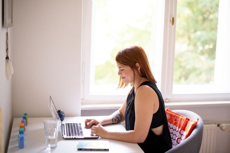 Woman at desk with orange ShaktiMat in back