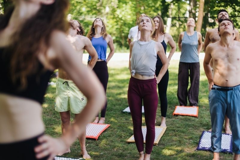 Group practicing yoga with ShaktiMat acupressure mat