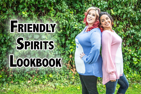 Friendly Spirits Lookbook - Katie Lynn (a light skinned model with red and blonde hair) and Oni (a medium skinned model with dark hair) model outdoors, wearing light blue and light pink sweaters inspired by a magic forest neighbor.