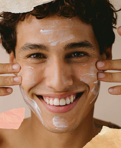 Close up of man's face with facial cleanser on it.