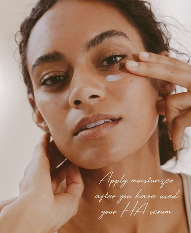 Close up of woman applying hyaluronic acid eye cream to her skin. 