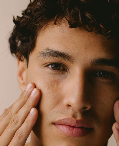 Closeup of a man's face with soft, hydrated skin from hyaluronic acid serum. 