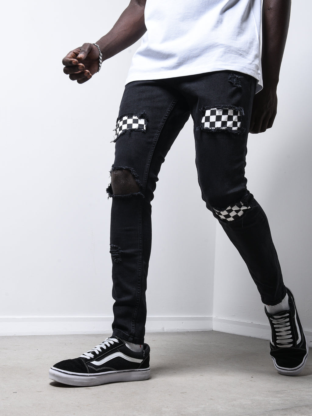 ripped jeans with checkered patches