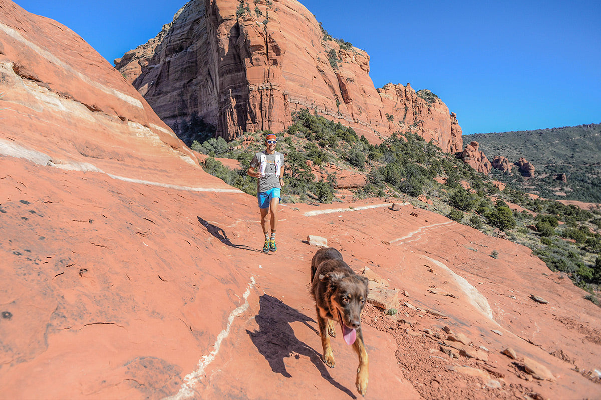 Sol and Nico trail run along red rocks through Utah.