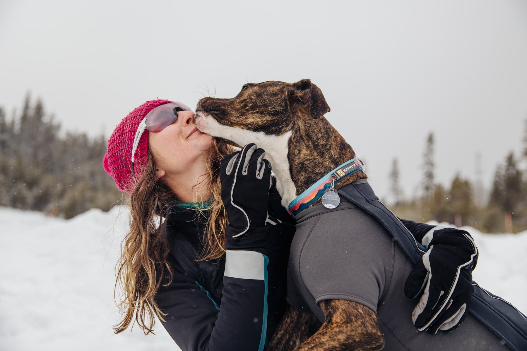 Juniper gives Kelly a smooch after skiing together.