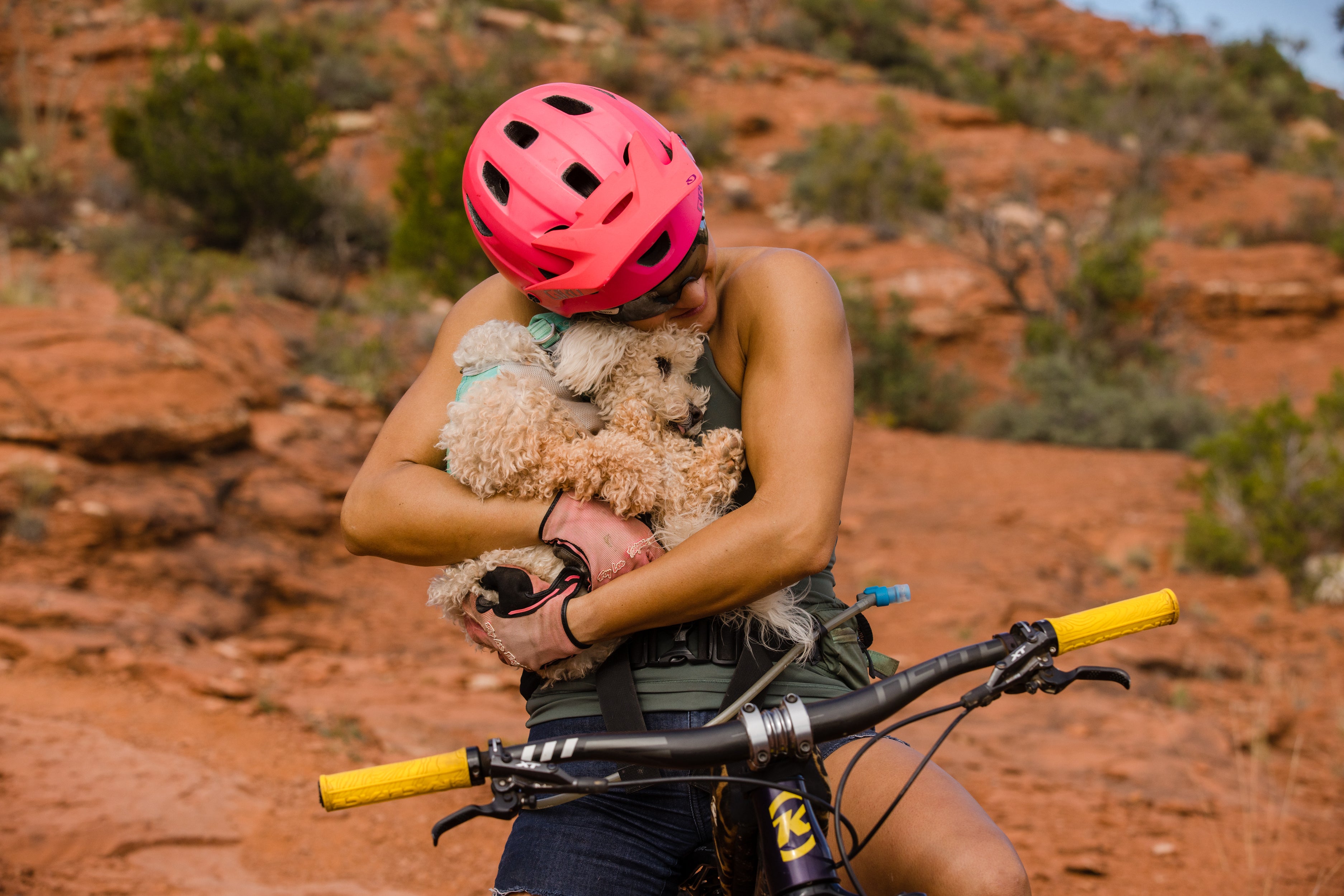 Abby hugging Mochi while on a bike