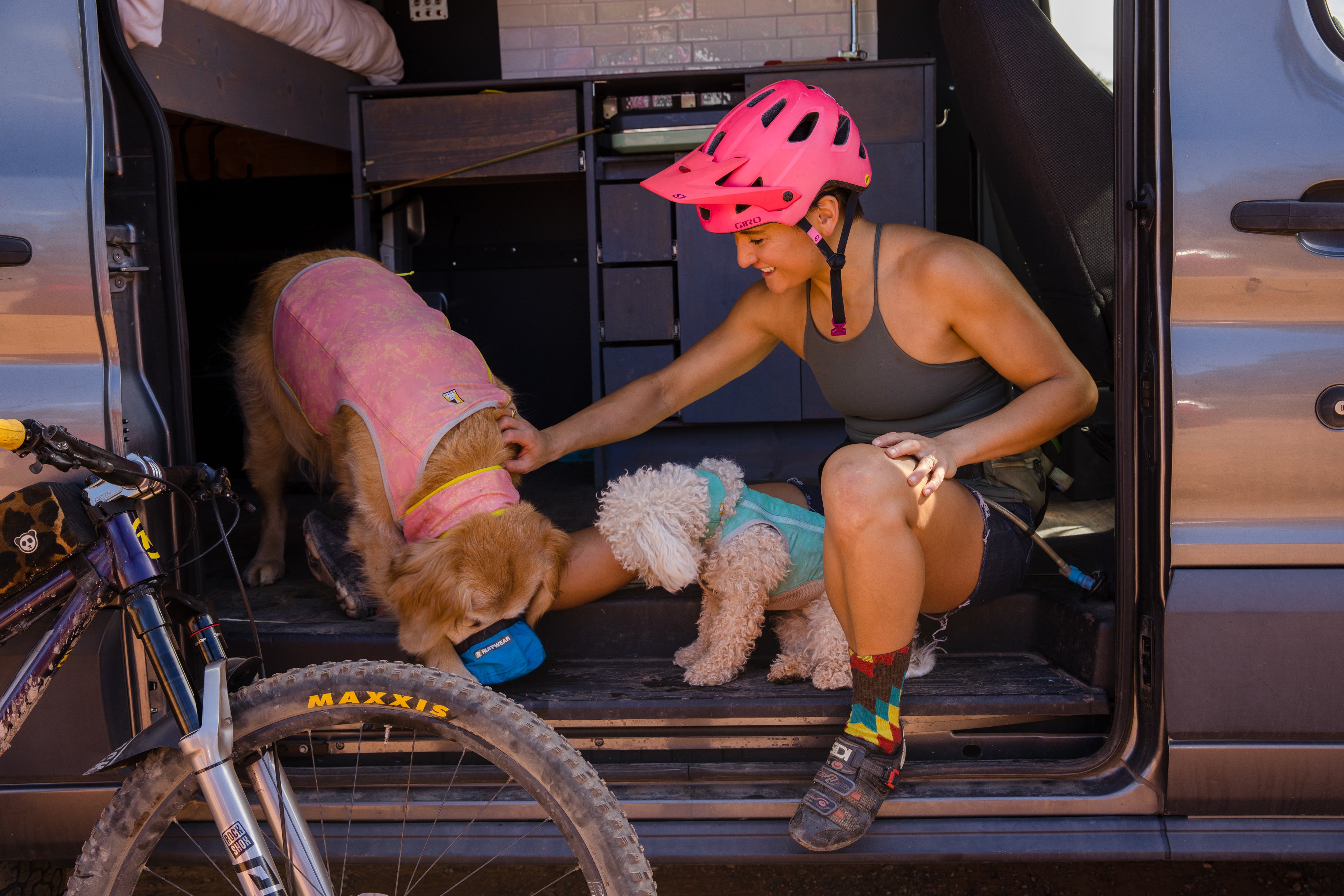 Abby and her dogs Kona and Mochi in a sprinter van 