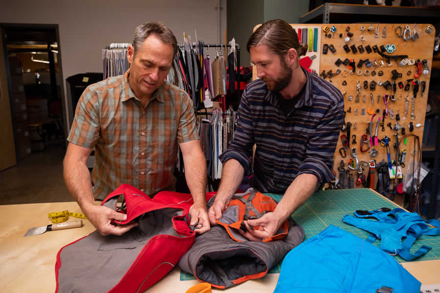 Product designers compare fabrics on prototypes of overcoat fuse.
