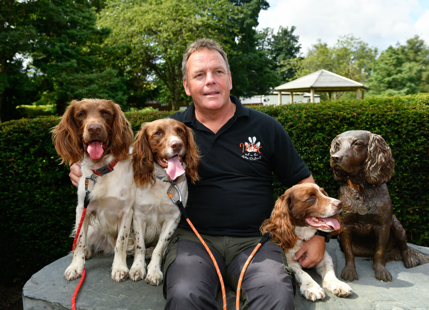 Kerry Irving sits with his three dogs: Max, Harry, and Paddy. 