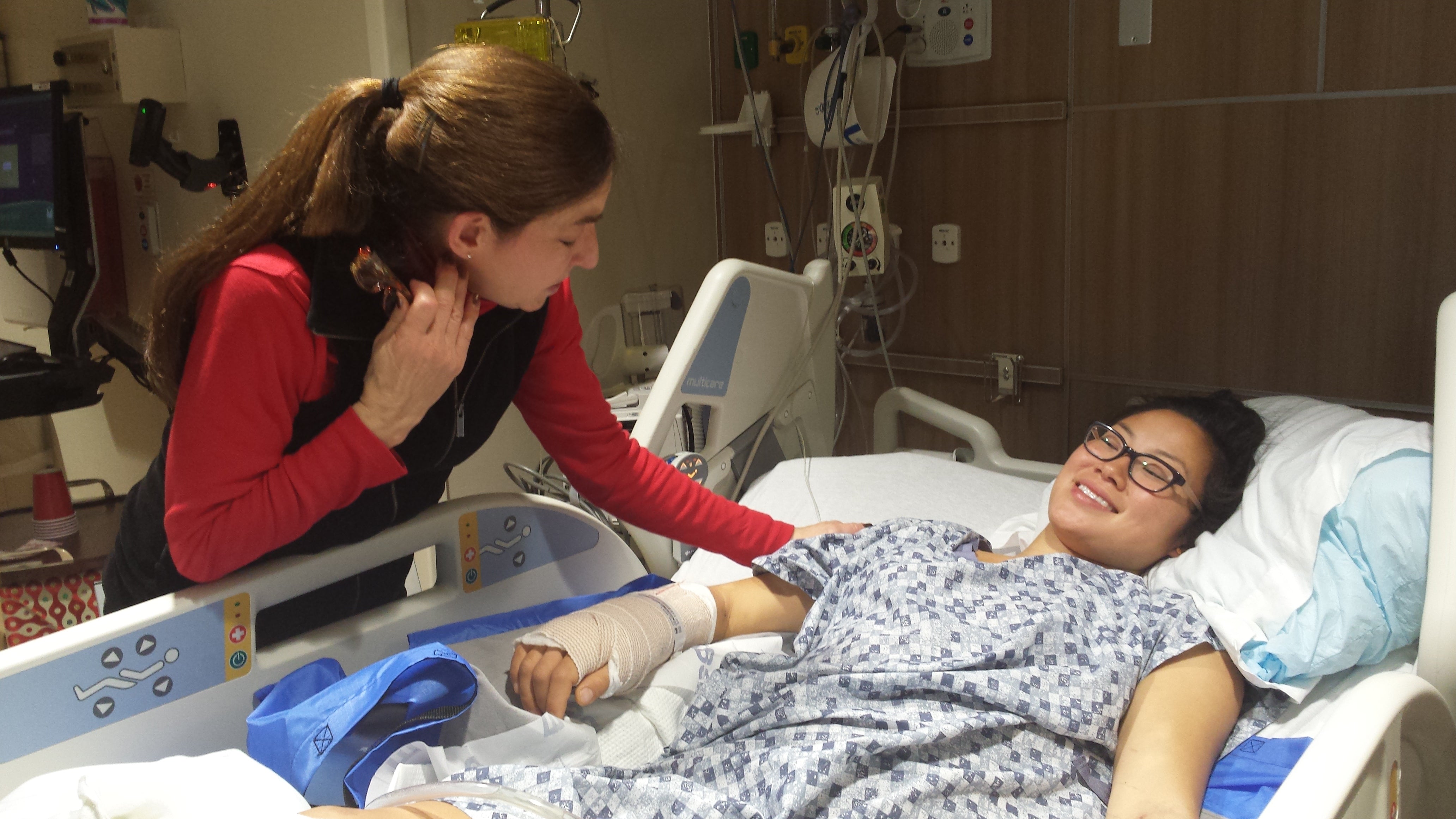 Anna in the hospital with her aunt looking down at her.