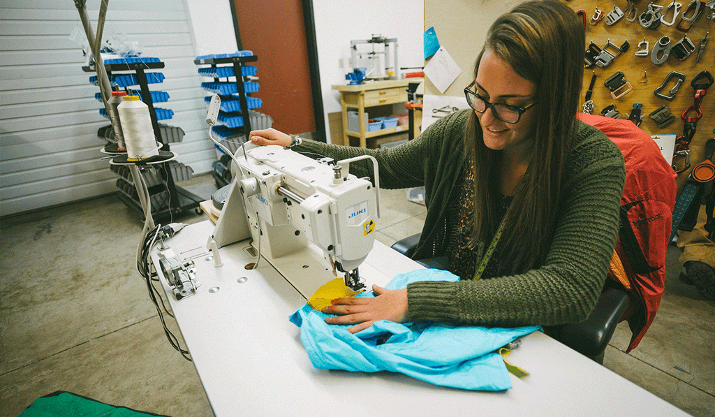 Product Developer Monica sews together a sample.