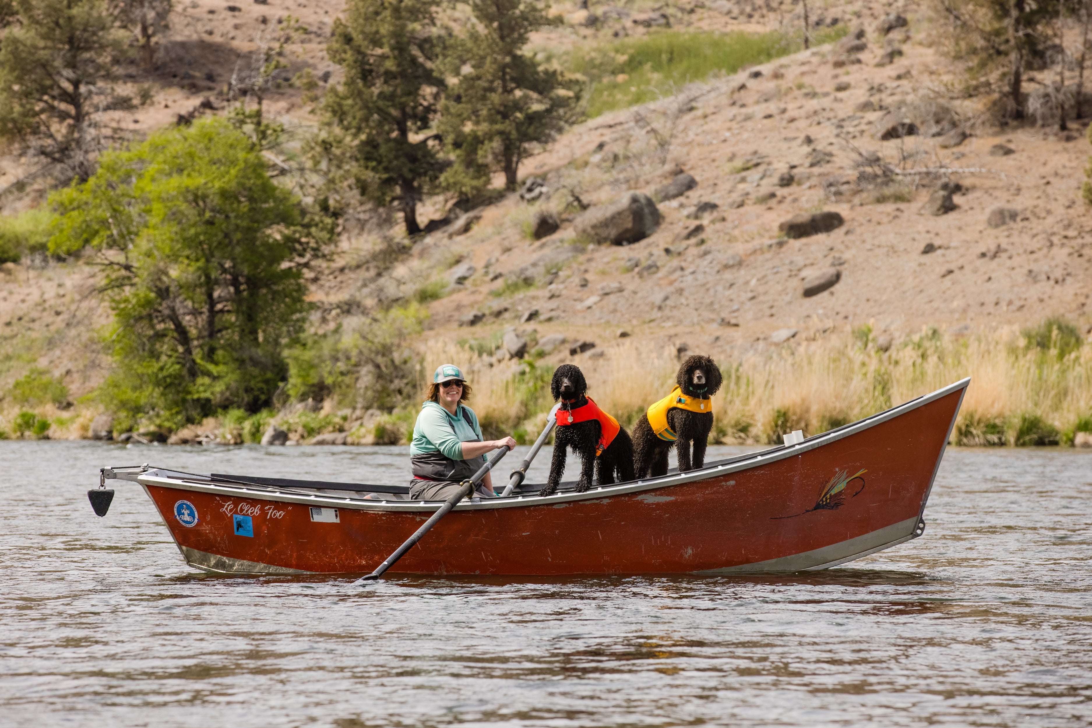 Dove rows on the Deschutes with River and Midge standing in the bow.