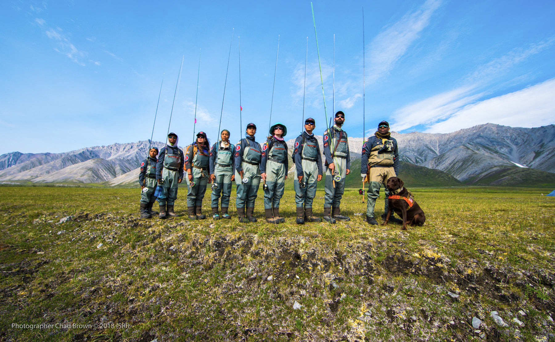 Soul River group in fly fishing gear pose as a group in front of the mountains.