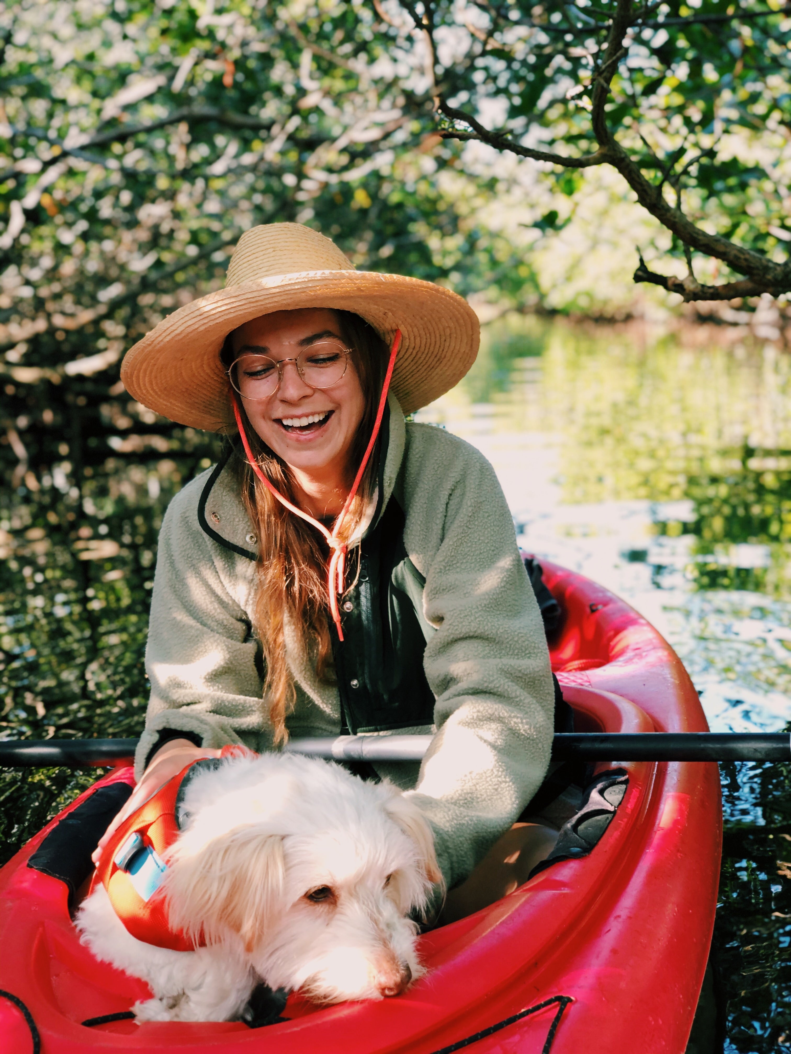 A woman, Katie, and her dog, Spaghetti, go kayaking together. 