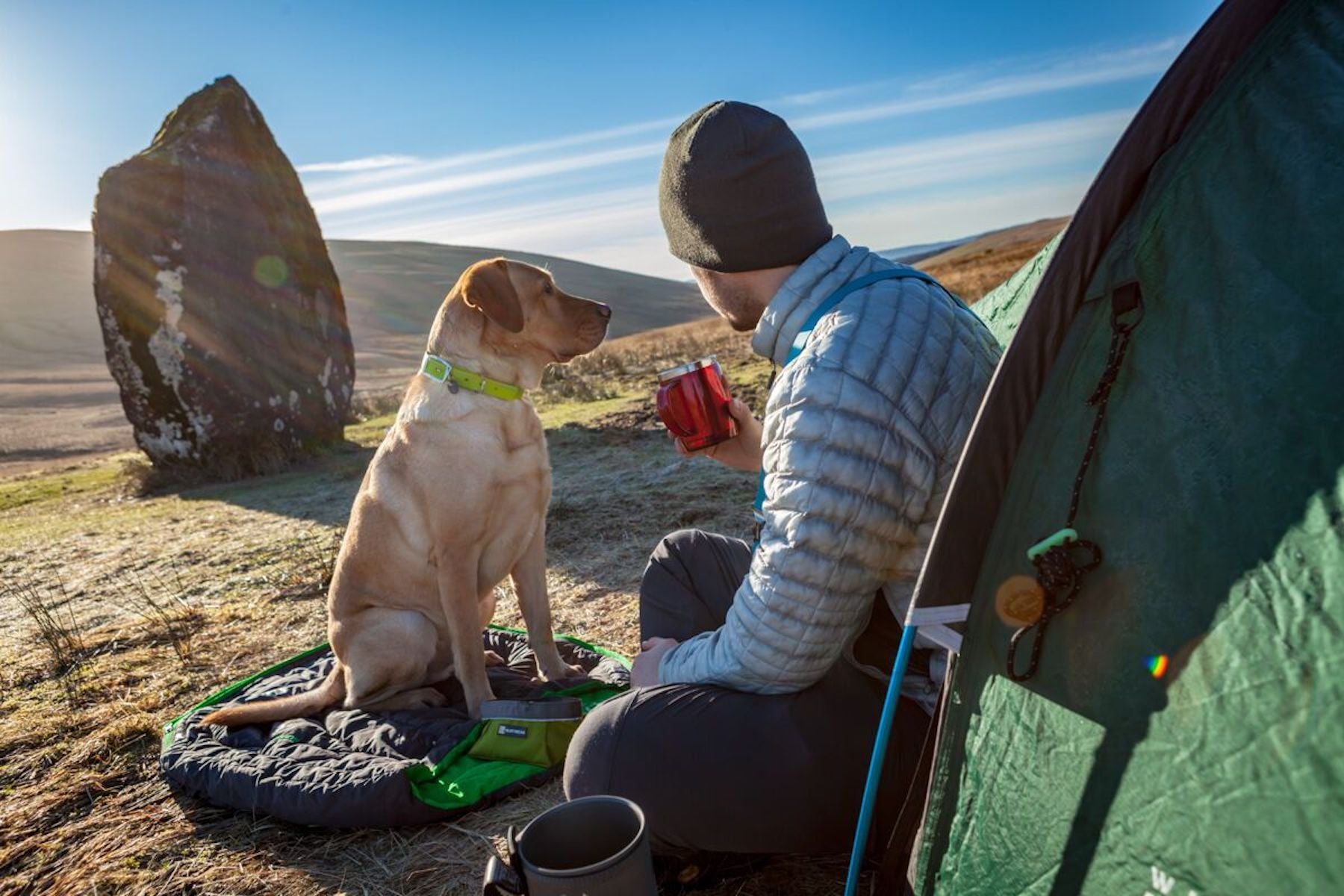 Dog and Human sitting outside their tent