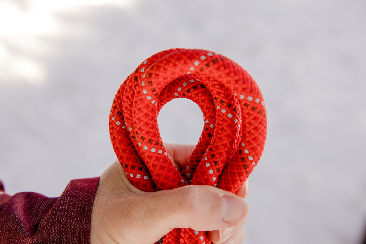 Person holding a red rope.