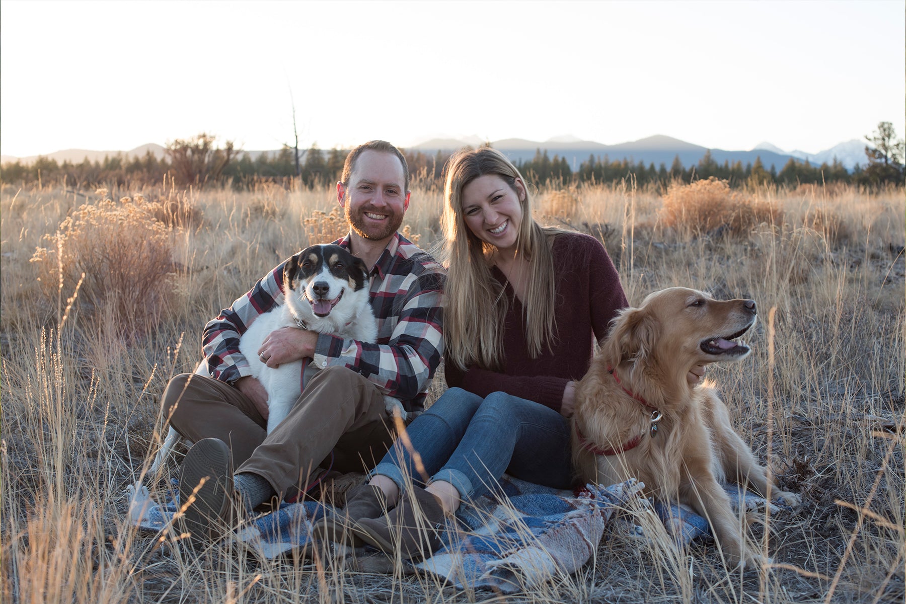 Portrait outside with two humans and two dogs