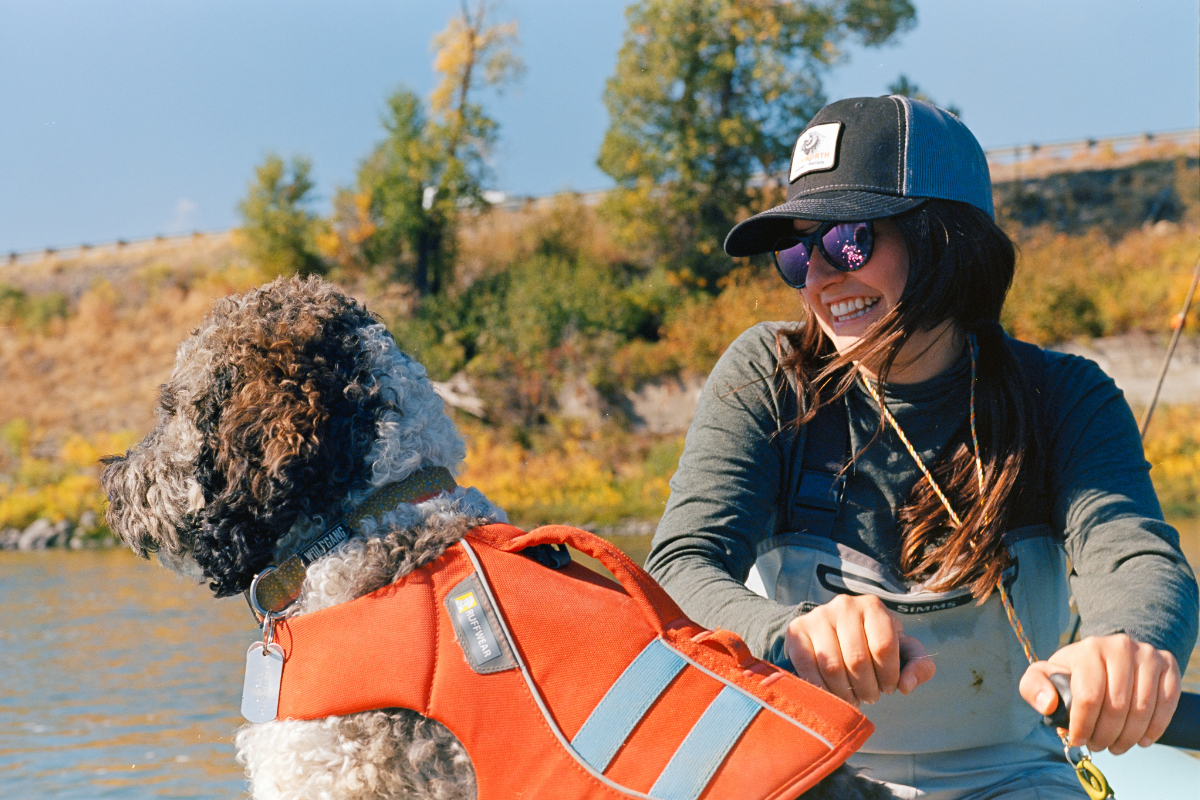 Gloria and her dog on a rafting adventure.