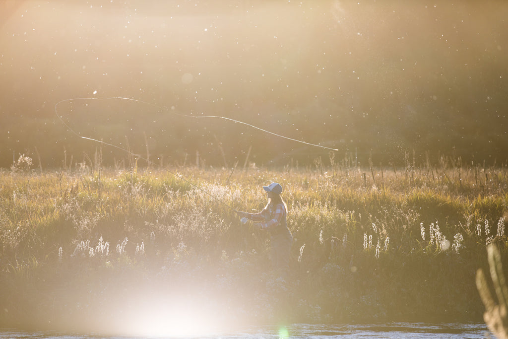 Jenny fly fishing on Metolius river.