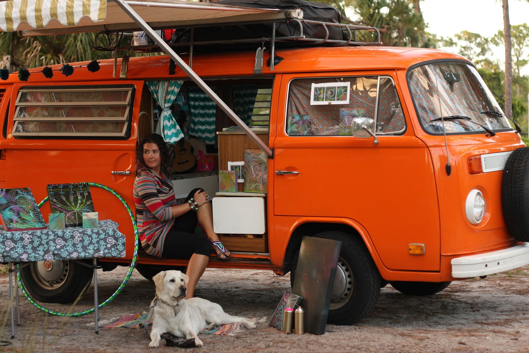 Mallory and Baylor hang out in her orange camper van.