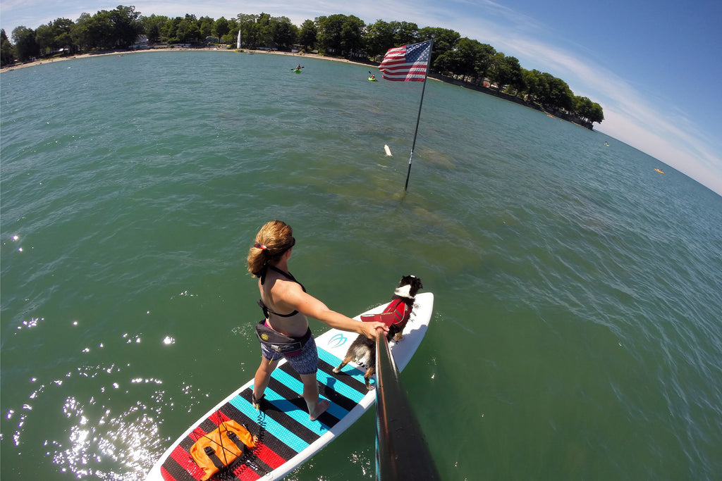 Maria and Kona paddling out to the American Flag in Lake Erie on the Fourth of July. 