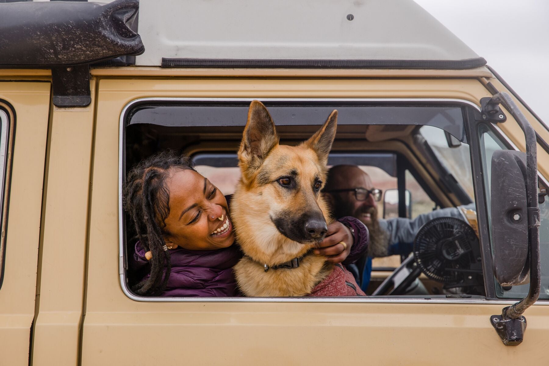 Dog and human looking out their camper van window