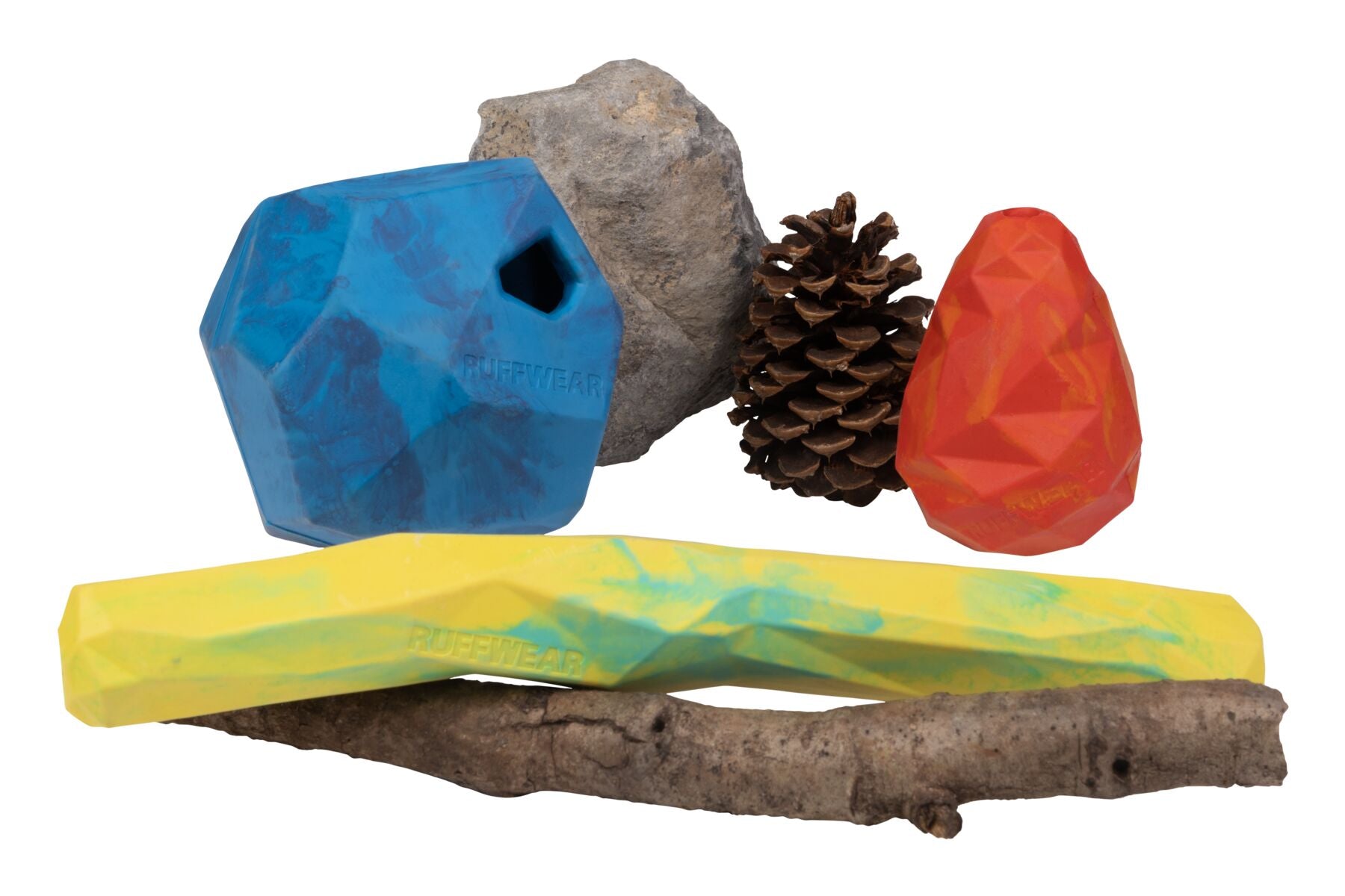 Picture of 3 Gnawt-a-toys next to a rock, a stick, and a pinecone. 