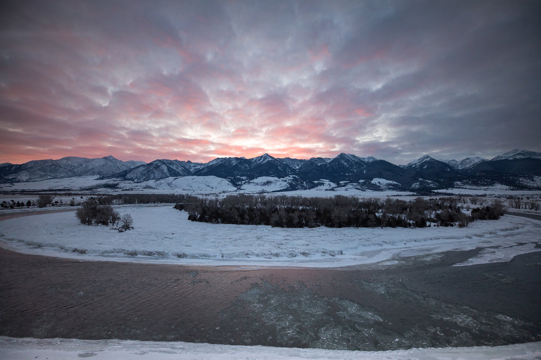 Sunset over snowy mountains in Paradise Valley in Montana.